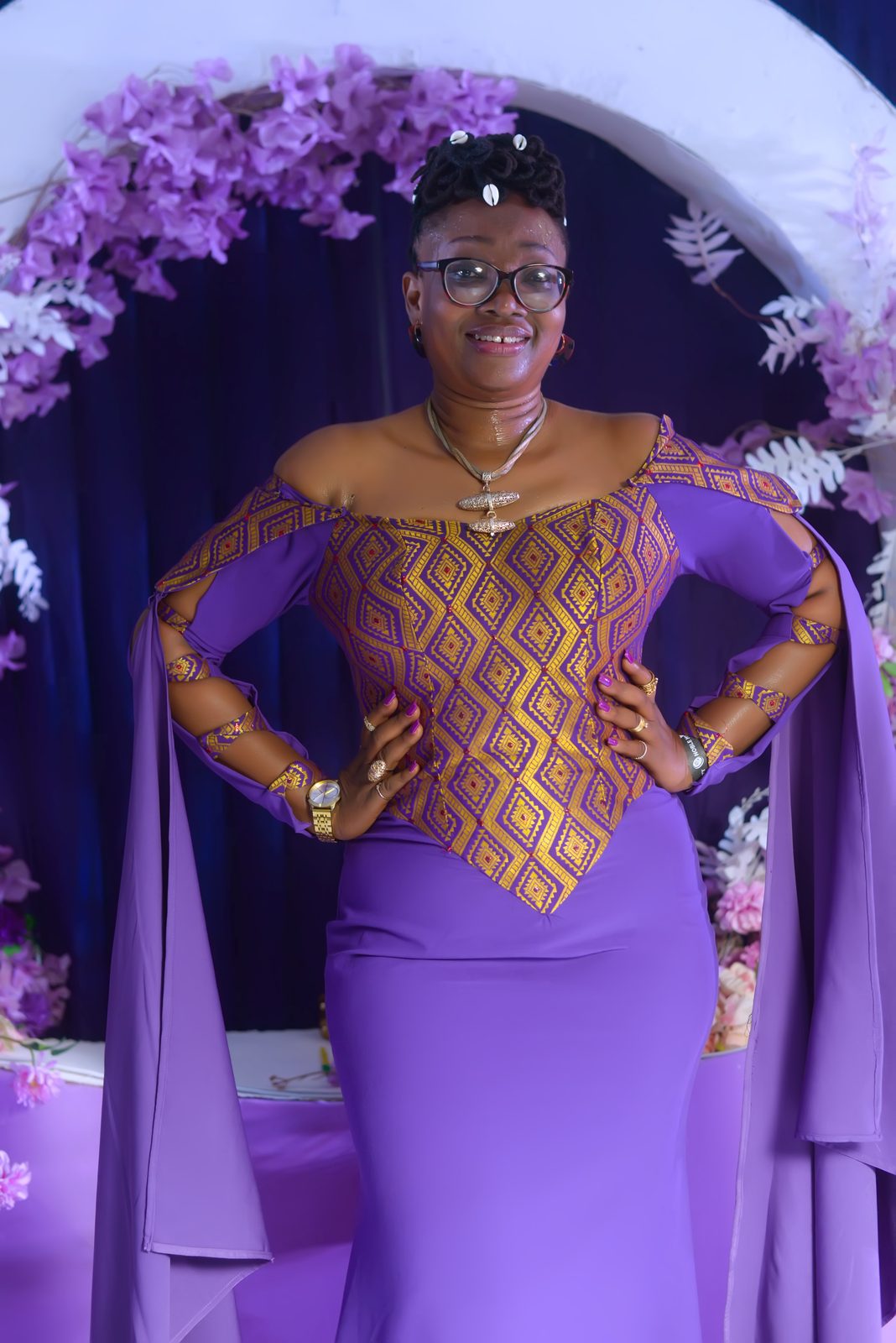 A guest in a caped purple and gold gown