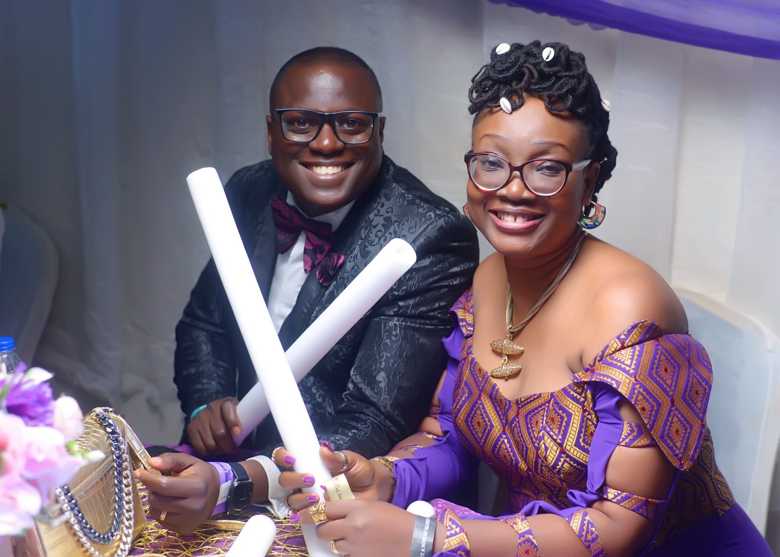 A couple holding glow sticks during the celebration
