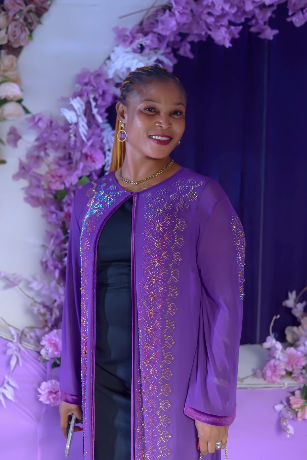 A guest in an embellished purple gown