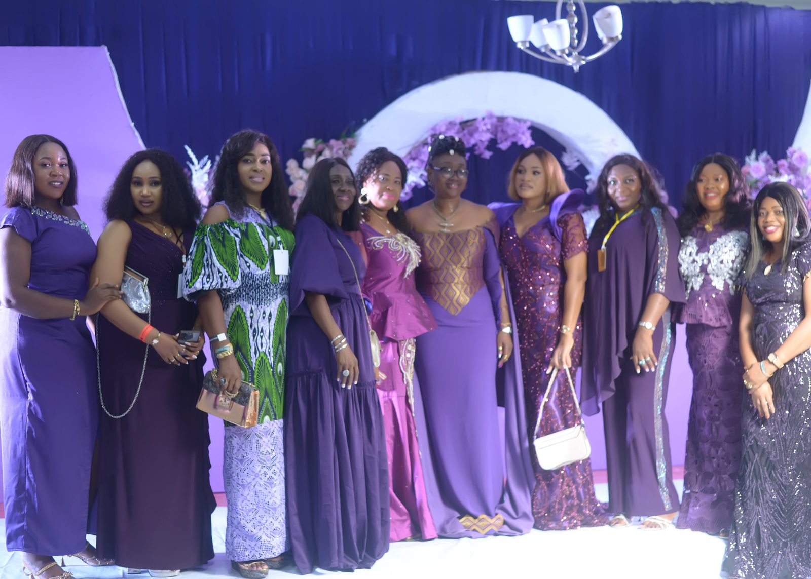 A group of friends gathered in purple and lilac