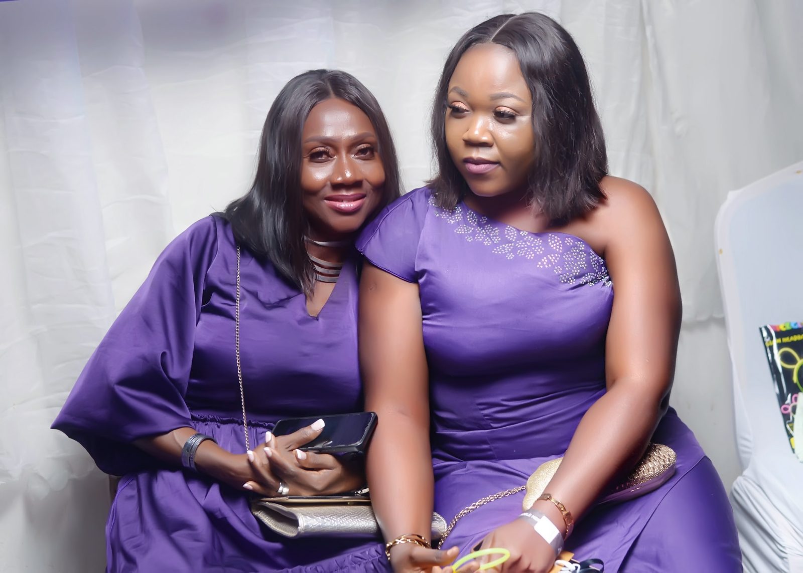 Two guests dressed in matching purple