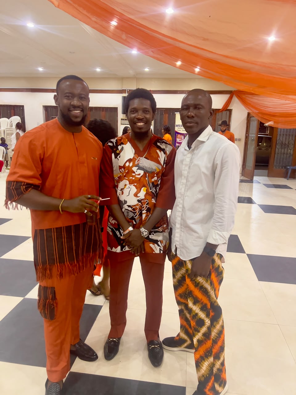 Three guests in coordinated terracotta attire